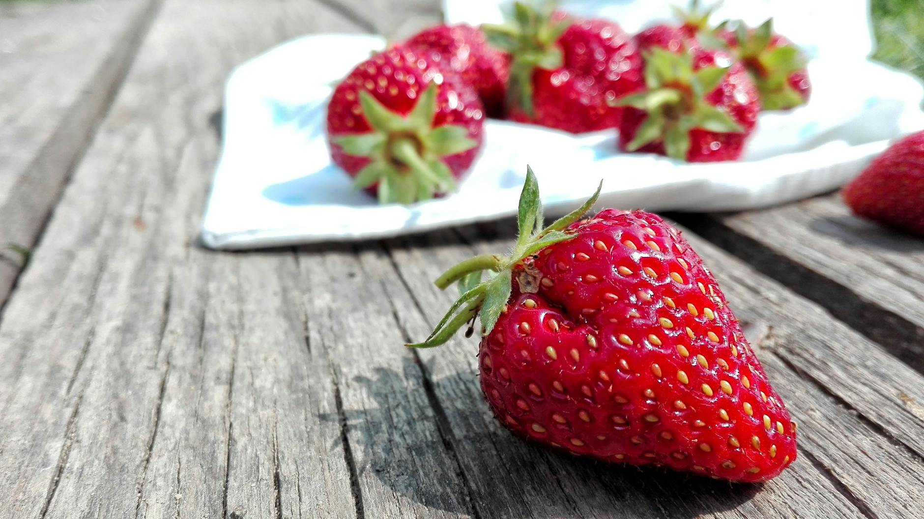 strawberries on top of brown table